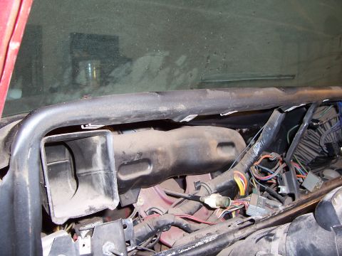 1978 Ford Bronco - Exposed wiring and ductwork are visible inside a vehicle's dashboard area.