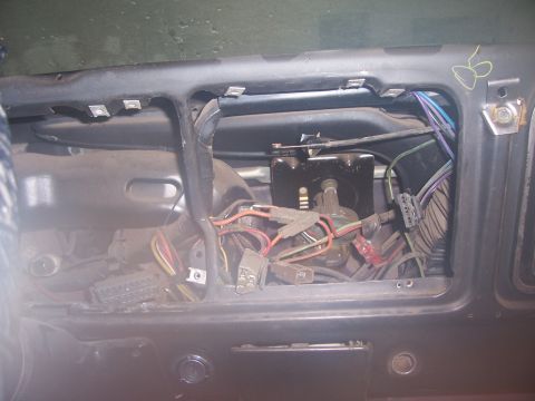 1978 Ford Bronco - Wiring harness visible behind the dash panel of a 1978 Ford Bronco during removal.