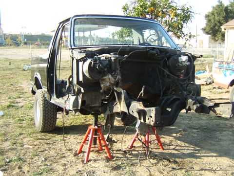 1988 Ford Bronco - Disassembled 1988 Ford Bronco chassis on jack stands, exterior view.