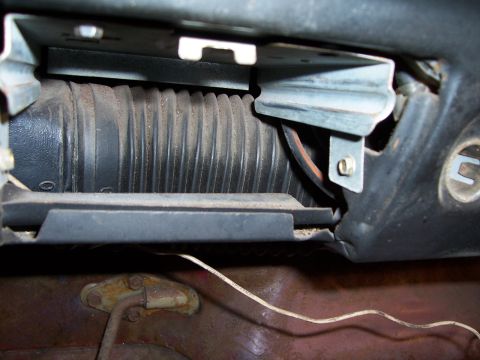 1978 Ford Bronco - Close-up view of the underdash ducting and metal mounting brackets inside a 1978 Ford Bronco.