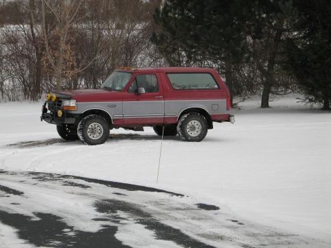 1995 Ford Bronco - Red and silver 1995 Ford Bronco in the snow.