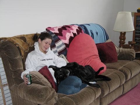 1995 Ford Bronco - A woman relaxes on a couch with her dog, a can of soda in her hand.