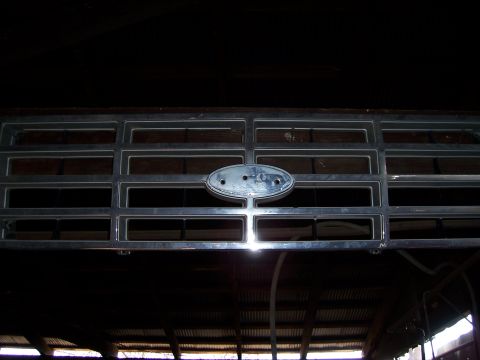 1983 Ford Bronco - Close-up of a Ford emblem on a chrome grille, likely from an older model truck or SUV.