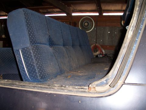 1983 Ford Bronco - Interior view of a dusty blue patterned rear bench seat inside a vehicle.