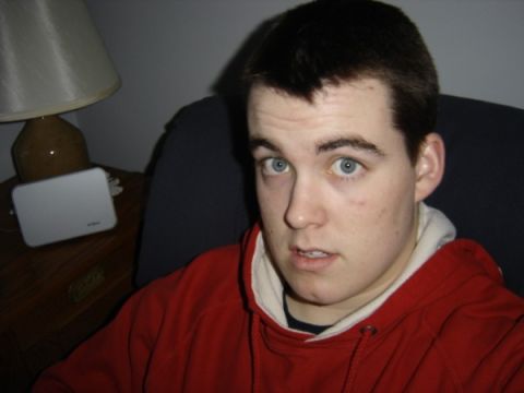 1999 Ford Taurus - A young man with striking blue eyes wears a red hooded sweatshirt while posing for a photo indoors.