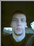 1983 Ford Bronco - A man takes a selfie inside a vehicle, looking directly at the camera.