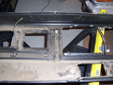 1978 Ford Bronco - Dusty dashboard frame with openings for gauges and controls, likely from an older vehicle.