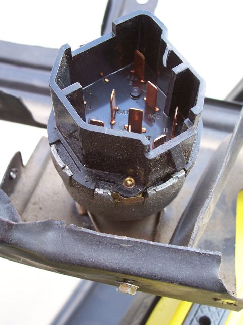 1978 Ford Bronco - Extreme close-up of a black plastic ignition switch connector plug with copper blade terminals, showing molded lettering for BAT, ACC and S…
