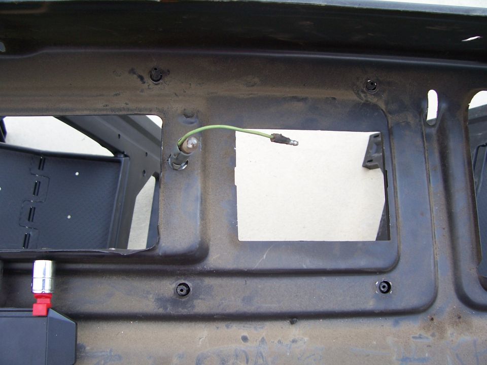 Underdash bracket with wiring harness and connector. Black plastic box with red adapter visible