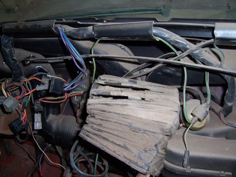 1978 Ford Bronco - Close-up view of the underdash wiring and a damaged HVAC component in a 1978 Ford Bronco.