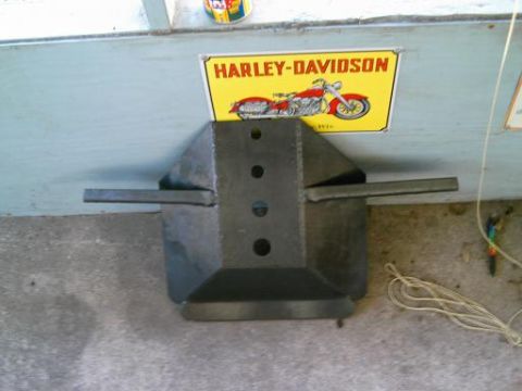 1986 Ford Bronco - A metal object is shown in front of a wall with a Harley-Davidson sign.