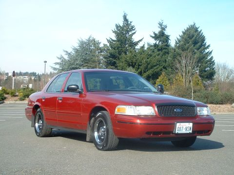 1999 Ford Crown Victoria - Red 1998 Ford Crown Victoria sedan with a black grille and chrome wheels.
