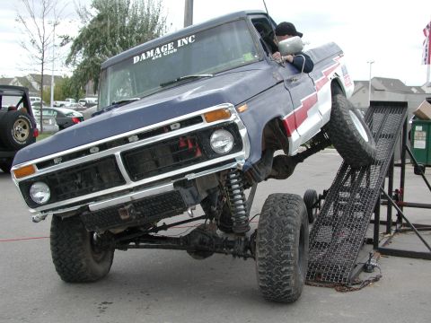 1977 Ford F-150 - This lifted 1977 Ford F-150 pickup is shown climbing a metal ramp, with a club sticker visible on the windshield.