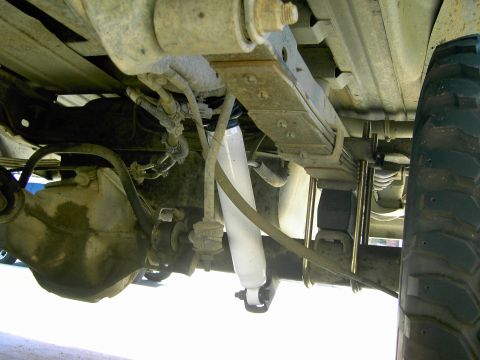 1988 Ford Bronco - The underside of a truck reveals its suspension components and a website address.