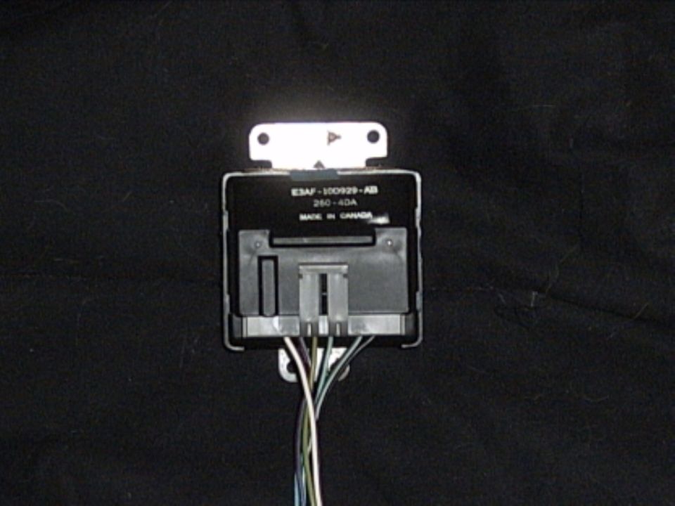 Automotive electronic control module with part number E3AF-100929-AB and 'MADE IN CANADA' text