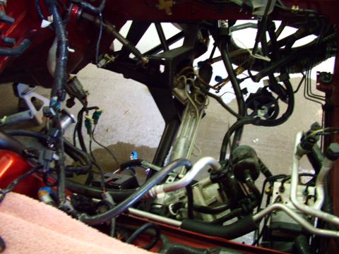 2003 Ford Mustang - Close-up of engine bay wiring and components, with Supermotors.net logo visible.