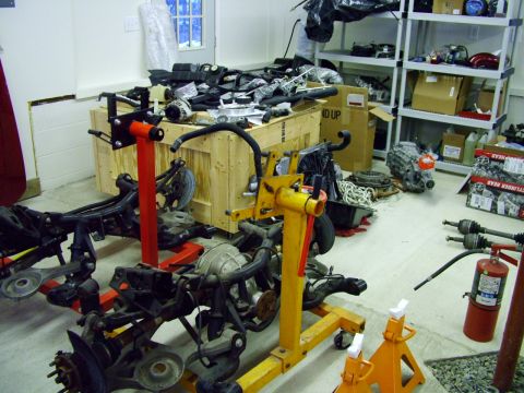 2003 Ford Mustang - Various automotive parts are organized and stored in a workshop environment.