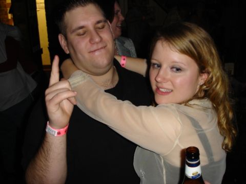 1985 Ford Crown Victoria LTD - Two people embrace at a party, one holding a beer bottle.