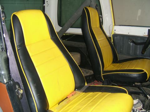 1989 Jeep YJ - Interior view of yellow and black seats with black trim.