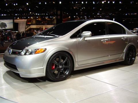 1997 Ford Taurus - Silver 2006 Honda Civic Si sedan shown at an auto show with aftermarket wheels.
