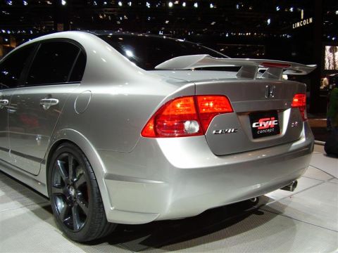1997 Ford Taurus - A silver Honda Civic concept car is displayed indoors, a prominent rear spoiler and custom wheels.