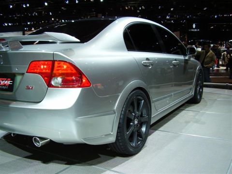 1997 Ford Taurus - A silver sedan, likely a Honda Civic Si concept, is displayed at an auto show with tinted windows and a prominent rear spoiler.