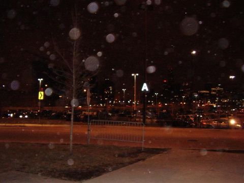 1997 Ford Taurus - A nighttime scene captures a distant city skyline, illuminated streetlights, and a parking lot, with a prominent "SUPERMOTORS" watermark at…