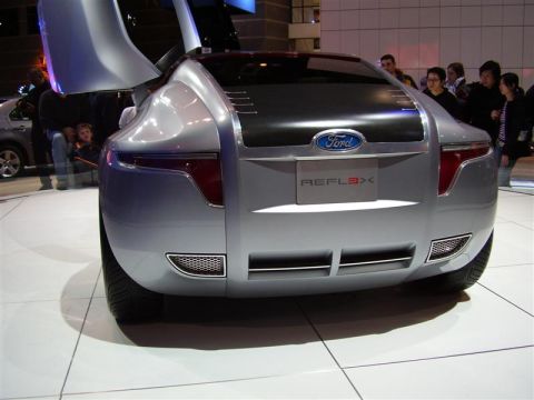 1997 Ford Taurus - The Ford Reflex concept car is displayed with its doors open, revealing its unique rear design and branding.