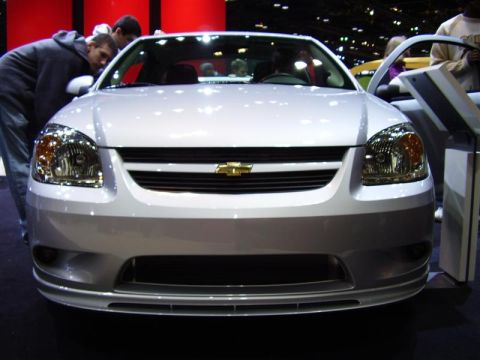 1997 Ford Taurus - This Chevrolet Cobalt is on display at an auto show, with people looking at it.