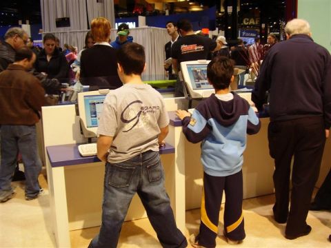 1997 Ford Taurus - Attendees engage with interactive displays at a public exhibition.
