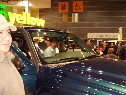 1997 Ford Taurus - A dark blue SUV is shown from the interior, with several people visible inside and around the vehicle.