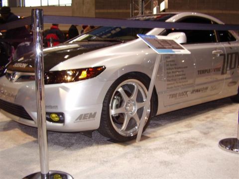 1997 Ford Taurus - Modified Honda Civic coupe at an auto show, custom paint and sponsor logos.