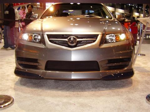 1997 Ford Taurus - This Acura TL features a distinctive front grille and bumper design, seen at an auto show.