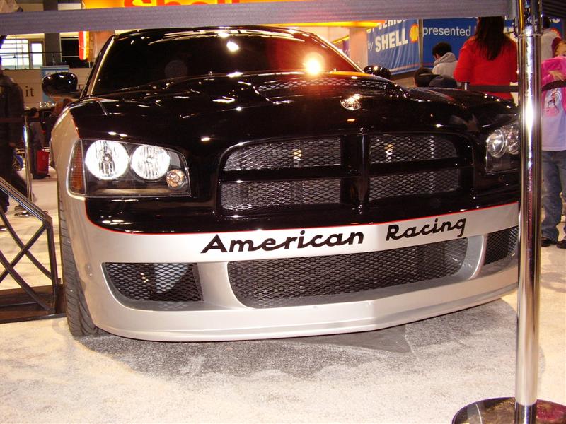 Black and silver car front view with "American Racing" text on bumper