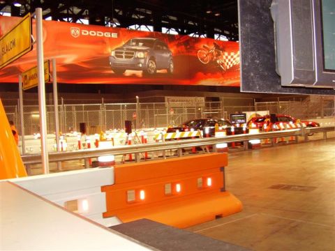 1997 Ford Taurus - Auto show display Dodge vehicles and promotional banners.
