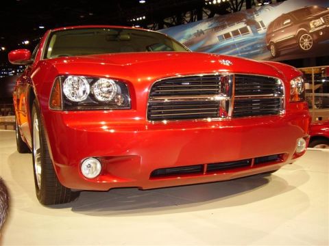 1997 Ford Taurus - Red Dodge Charger on display at an auto show.