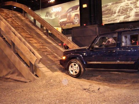 1997 Ford Taurus - A Jeep Commander navigates an obstacle course at an auto show.