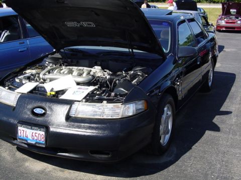 1998 Ford Taurus - The 1998 Ford Taurus SHO is shown with its hood open, revealing the engine compartment.