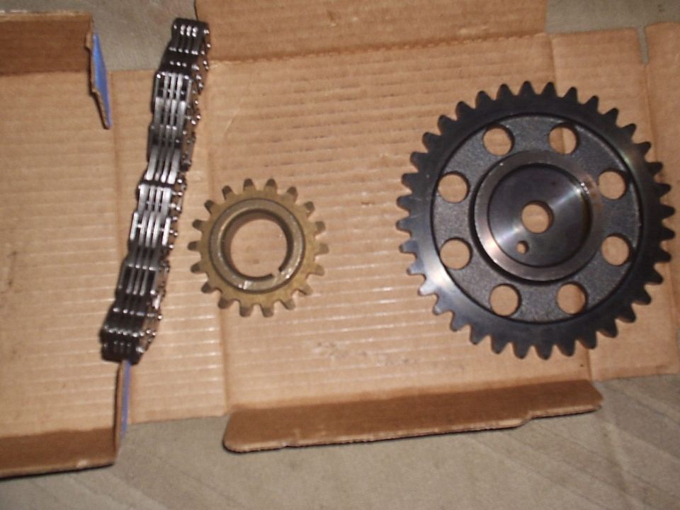 Timing chain, small crank gear, and large cam sprocket on cardboard