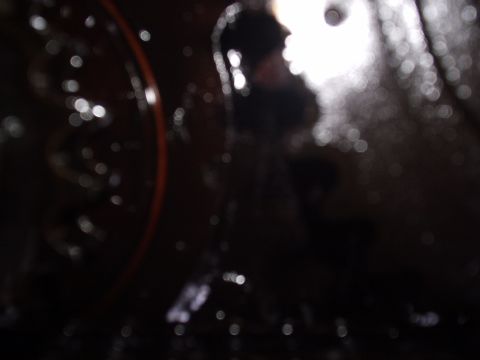 1989 Ford Bronco - Blurred image of an engine component, possibly a water pump, with fluid present.