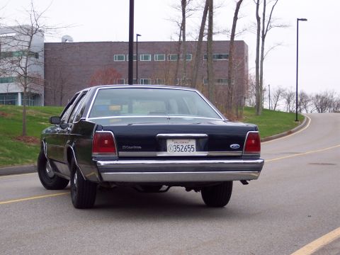 2001 Ford Crown Victoria - Rear view of a dark blue 2001 Ford Crown Victoria, identified by its body style and badging, with a California license plate.