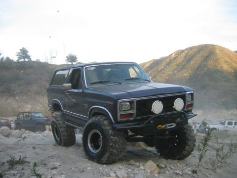 1985 Ford Bronco - Modified 1985 Ford Bronco equipped for off-road adventures on a rocky trail.