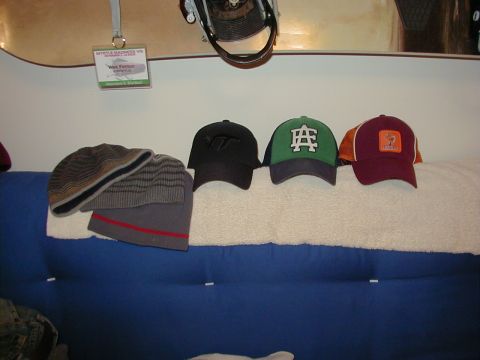 1994 Ford Probe - A collection of hats and a snowboard are displayed, with a name tag visible on the wall.