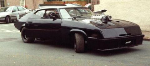 1972 Ford Ranchero - This modified coupe features a prominent supercharger and a spoiler, with another vehicle visible in the background.