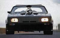 1972 Ford Ranchero - This modified vehicle features a large hood scoop and a helmet visible through the windshield, captured from a front-facing perspective.