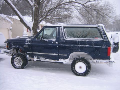 1994 Ford Bronco - 1994 Ford Bronco covered in snow during winter weather.