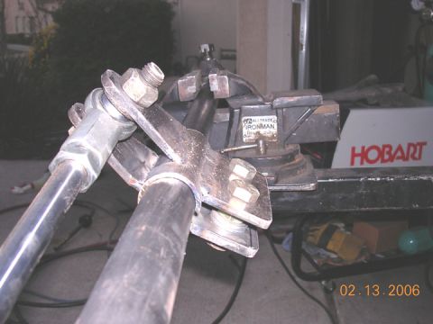 1994 Ford Bronco - Metal fabrication project held in a vise, with a Hobart welder visible in the background.