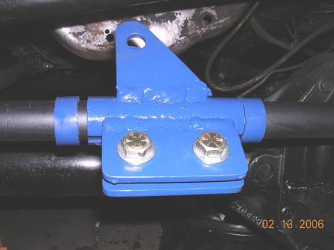 1994 Ford Bronco - Close-up view of a blue aftermarket suspension component mounted to a vehicle's chassis.