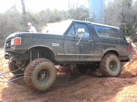 1991 Ford Bronco - This Ford Bronco is covered in mud after navigating a challenging off-road course.