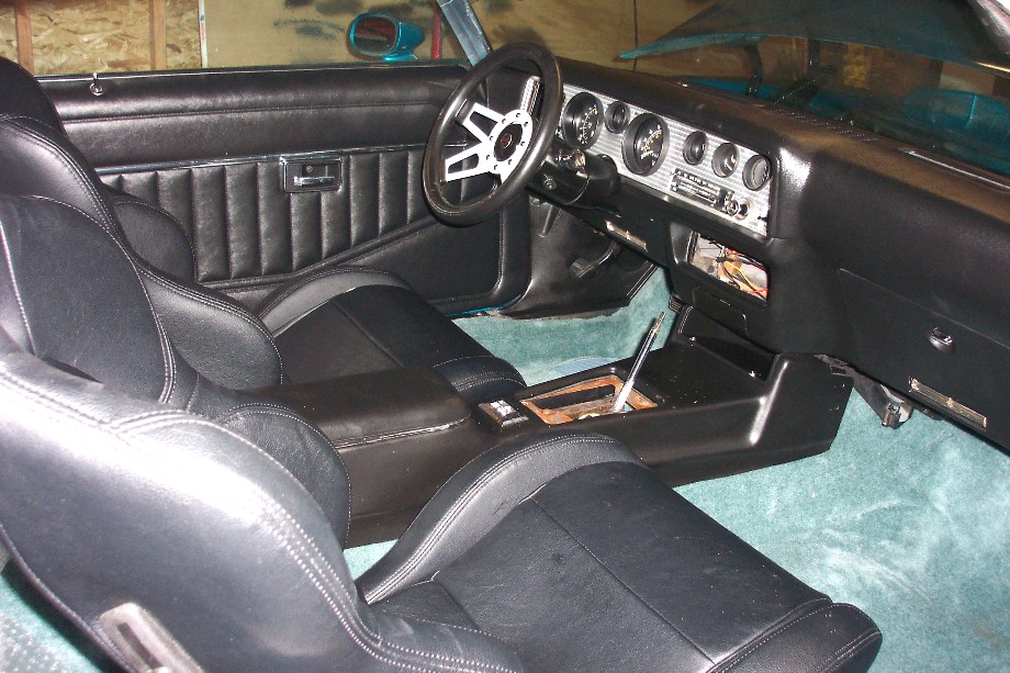 1979 Pontiac Trans Am interior showing black bucket seats, dashboard with gauges, and center console